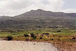 Photograph of the reservoir with a hill in the background