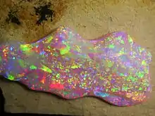 Brazilian Crystal Opal. The play of color is caused by the interference and diffraction of light between silica spheres (150–300 nm in diameter).