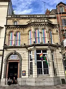 Terraced building with LGBTQ+ flags and sign 'Mary's'