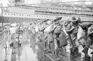 Soldiers leave a large ship