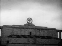 the massive svastika on top of the Nuremberg rally building moments before being destroyed