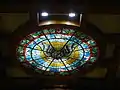 Stained glass depicting Holy Spirit on the ceiling above the altar