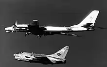 A Soviet Tu-95RT Bear-D being intercepted by an A-7E Corsair II from VA-146 in 1984.