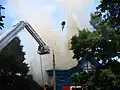 Firefighters hose down the building