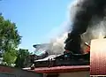 Black smoke from the warehouse - synthetic fabrics on fire