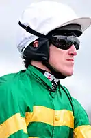 Modern jockey with head and eye protection.