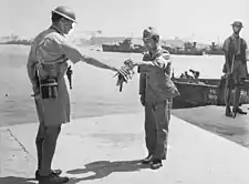 Image 3530 August 1945. Yokosuka Naval Base, Tokyo Bay. Commander Yuzo Tanno hands over the keys of Yokosuka Naval Base to Captain H. J. Buchanan, Royal Australian Navy. Buchanan led the first Commonwealth party to go ashore in Japan. (from History of the Royal Australian Navy)