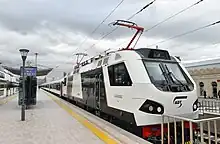 Electric locomotive AZ4A-0002 with passenger coaches at the station, 2019