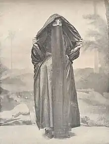 A veiled woman in traditional dress, 1918