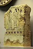 Glazed terracotta tile from Nimrud, with a court scene; 875–850 BC; fired and glazed clay; height (without base): 30.6 cm, height (with base): 38.3 cm; British Museum