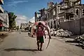 Image 3A man carries a huge hammerhead shark through the streets of Mogadishu