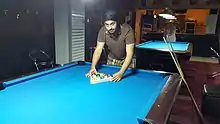 Image 1A player racking the balls (from Pool (cue sports))