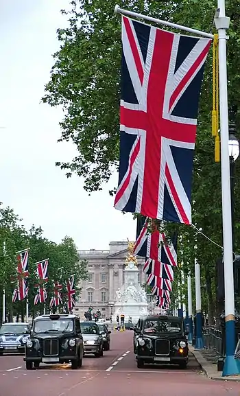 Image 69Union Flag being flown on The Mall, London looking towards Buckingham Palace (from Culture of the United Kingdom)