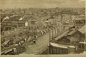 Lithograph of a crowded Chinese city street showing people, horses with carts, and buildings.