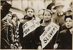 Two girls protesting child labour (by calling it child slavery) in the 1909 New York City Labor Day parade.