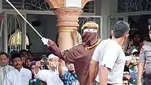 Image 98Public caning in Aceh. The westernmost special province is one of the few regions within Indonesia that implement full Islamic sharia law, where public caning is frequently held. Caution is required for visitors regarding clothing, modesty issues, morality and consumption of alcohol, to avoid troubles with the local authority. (from Tourism in Indonesia)