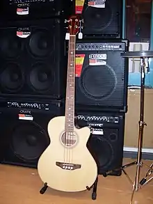 A display of bass amplifiers and bass speaker cabinets at a music store.