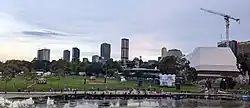 Adelaide City Skyline during 2022 Australia Day Celebrations Forefront: Torrens River, Elder Bank and Riverbank Precinct.  From Right to Left: Stanford Hotel, Convention Centre, Myer Centre, The Switch, Realm Adelaide, Frome Central Tower One, GSA North Terrace, Schulz Building (Adelaide University).