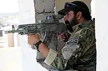 Afghan border police aiming an AK type rifle with Picatinny rails, holographic weapon sight and foregrip