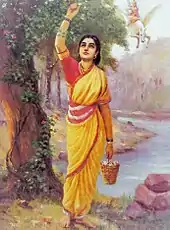 Ahalya clad in a yellow sari stands, plucking flowers from a tree. In the background (right top), Indra astride his flying horse.