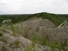 Unrehabilitated land in older part of Aidu mine.