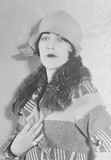 Actress Aileen Pringle wearing a cloche hat and boldly patterned coat, 1926.