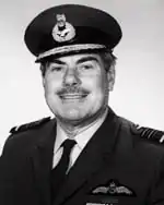 Head-and-shoulders portrait of mustachioed man in dark military uniform with peaked cap