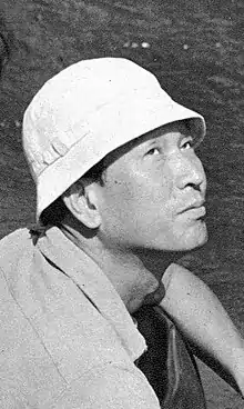 A Japanese man in a bucket hat