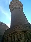 Ground level view of the first bands of the muqarnas and the decorations of the minaret.