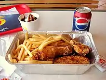 An Albaik chicken meal with fries, soft drink and ice cream