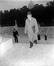 Photograph of a man smiling while walking