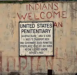 Prison sign on building and the Indian graffiti