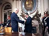 Outgoing President Reynaldo Bignone (the last president of the 1976 military dictatorship) gives the presidential sash and staff to President–elect Raúl Alfonsín in 1983