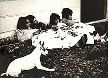 Black-and-white photo of the band lying on the ground