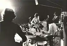 Black-and-white photo of the band onstage