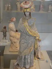 Greek statue of a woman with blue and gilt garment from Tanagra, 325–300 BC, gilt and painted terracotta, Antikensammlung Berlin, Berlin, Germany