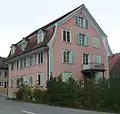 A less common form of gambrel roof with a curved lower roof slope with supporting curved soffits and thick tiles, Altnau, Switzerland