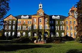 Saint Anselm College's Alumni Hall, rebuilt in 1893 after a devastating fire, was the first monastery complex for Saint Anselm Abbey