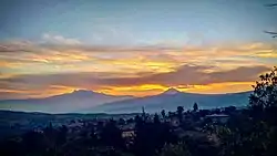 Iztaccíhuatl (left) and Popocatépetl (right) from the community of San Bartolomé Xicomulco, Milpa Alta.