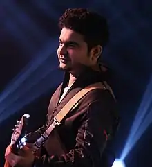 Ami performing at a gig in June 2017