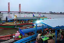 Floating warung on boat on the bank of the Musi River, Palembang.