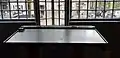 Post office: a writing desk in front of a design protruding window frame