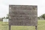 An_etched_wooden_sign_"Amache_Japanese_Relocation_Camp,"_complete_with_outlines_of_buildings,_one_of_the_only_remnants,_save_for_a_few_cement_foundations_a_little_nearby_graveyard,_of_the_Amache_Camp_LCCN2015632197