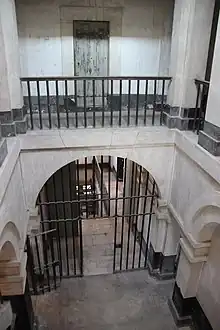 Color photograph of a multi-level courtyard lined with columns and staircases.