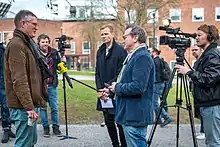 A photograph of Tegnell being interviewed outside the Karolinska Institute