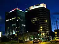 Andersia Tower (left) and Poznań Financial Centre (right) at night.