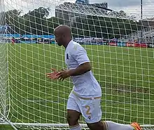 Player running behind the net to exit the pitch