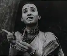 A black-and-white picture of a man posing as woman