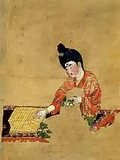 Image 7Painting of a woman playing Go, from the Astana Graves. Tang dynasty, c. 744 CE. (from Go (game))