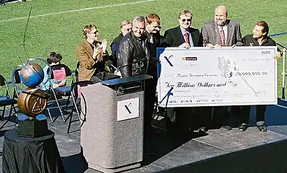 Representatives of the X Prize Foundation symbolically presented the ten million dollar prize to Burt Rutan and Paul Allen of Mojave Aerospace Ventures on November 6, 2004.  The Ansari X Prize trophy is on the left.